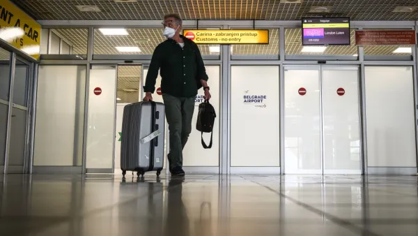 A passenger from London arrives at Belgrade's airport on May 18, 2020. With limited number of flights, air travel has resumed at Serbia's main airport after the authorities approved the airport to gradually resume operations with new guidelines amid the COVID-19 pandemic. Only passengers with tickets are allowed into the airport building four hours ahead of their flight. Andrej ISAKOVIC / AFP