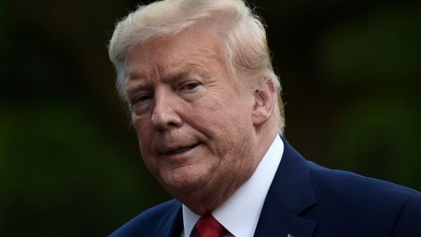 US President Donald Trump walks across the South Lawn upon his return to the White House in Washington, DC on May 27, 2020. SpaceX's landmark launch to the International Space Station -- the first crewed mission to blast off from US soil in almost a decade -- was scrubbed today due to bad weather. Olivier DOULIERY / AFP