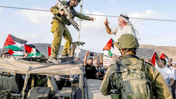 A Palestinian protester yells at an Israeli soldier during a protest in a residential area near the Palestinian village of Naqura, north-west of Nablus in the occupied West Bank, September 4. (AFP)