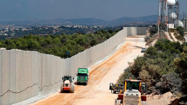 Near the Rosh Hanikra border crossing in northern Israel, shows tractors along a new wall on the Israeli-Lebanese border. AFP