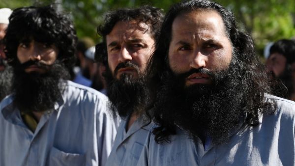 Taliban prisoners stand during their release from the Bagram prison, next to the US military base in Bagram, some 50 km north of Kabul on May 26, 2020. Afghan authorities plan to release 900 more Taliban prisoners on May 26, as calls grow for the militants to extend a ceasefire on its third and final day. WAKIL KOHSAR / AFP