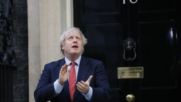 Britain's Prime Minister Boris Johnson participates in a national "clap for carers" to show thanks for the work of Britain's NHS (National Health Service) workers and other frontline medical staff around the country as they battle with the novel coronavirus pandemic, outside 10 Downing Street in London on May 28, 2020. Tolga AKMEN / AFP