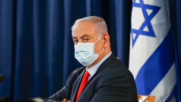 Israeli Prime Minister Benjamin Netanyahu, wearing a protective face mask, chairs the weekly cabinet meeting in Jerusalem on May 31, 2020. RONEN ZVULUN / POOL / AFP
