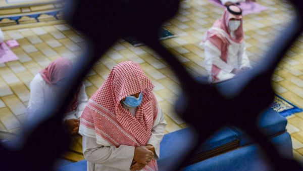 Saudi Muslims worshippers observe a safe distance as they perform noon prayer at Al-Rajhi mosque in the capital Riyadh on May 31 ,2020, after authorities eased lockdown measures for prayers in mosques. FAYEZ NURELDINE / AFP