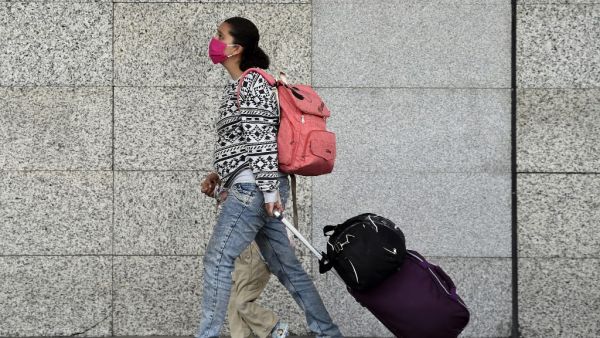 Passengers arrive on foot at Benito Juarez International Airport as employees block an access to the air terminal in demand of the payment of utilities, in Mexico City on June 1, 2020. (AFP)
