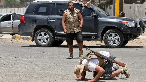 A fighter loyal to the UN-recognised Libyan Government of National Accord (GNA) prostrates in prayer as an expression of gratitude as his comrades celebrate in the Qasr bin Ghashir district south of the Libyan capital Tripoli on June 4, 2020, after the area was taken over by pro-GNA forces following clashes with rival forces loyal to strongman Khalifa Haftar. The GNA said on June 4 that it was back in full control of the capital and its suburbs after more than a year of fighting off an offensive by eastern 