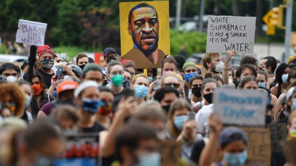 A protester holds up a portrait of George Floyd during a "Black Lives Matter" demonstration in front of the Brooklyn Library and Grand Army Plaza on June 5, 2020 in Brooklyn, New York, amid ongoing protests over Floyd's death in police custody. Angela Weiss / AFP