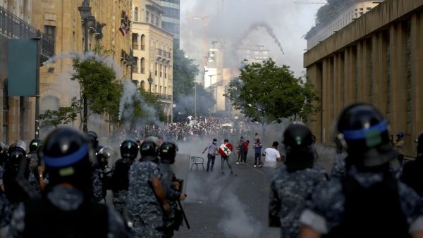 Lebanese riot police fire tear gas at protesters in central Beirut on June 6, 2020. Protesters poured into the streets of the Lebanese capital to decry the collapse of the economy, as clashes erupted between supporters and opponents of the Iran-backed Shiite group Hezbollah. PATRICK BAZ / AFP