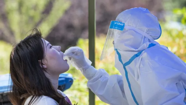 A medical worker takes a swab sample from a student to be tested for the COVID-19 coronavirus at Wuhan University, on the first day of classes in Wuhan on June 8, 2020. Final year students returned to campuses in Wuhan after universities were reopened following a months-long closure due to the coronavirus. STR / AFP