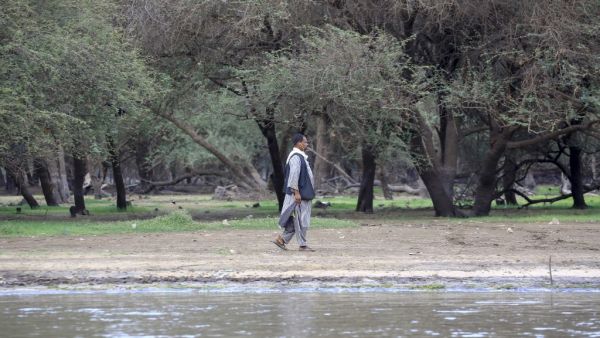 A man walks on the shore of the Nile river in the Sudanese capital Khartoum on June 9, 2020. ASHRAF SHAZLY / AFP