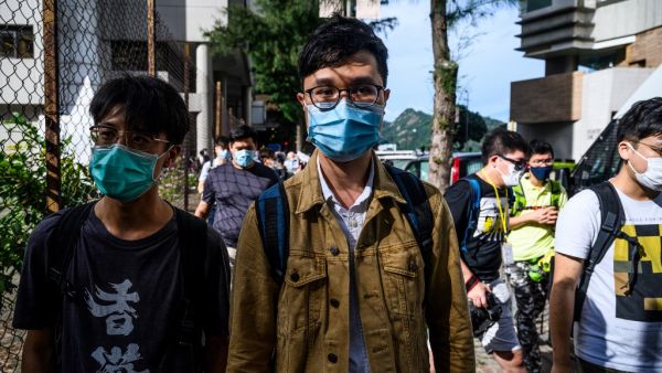 Local politician Ventus Lau (C) leaves the Eastern District Court in Hong Kong on June 10, 2020, after appearing in court on charges of illegally entering the Legislative Council government complex during protests on July 1, 2019. Hong Kong prosecutors on June 10 slapped additional riot charges against a group of prominent pro-democracy figures who allegedly joined crowds that broke into the city's legislature in 2019, increasing their potential jail sentence to a decade. Anthony WALLACE / AFP