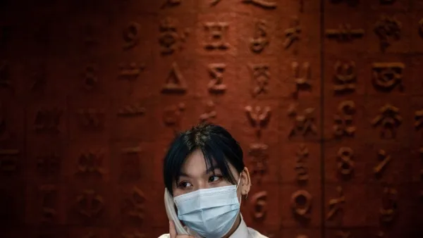 This photo taken on June 14, 2020 shows a staff member talking in the phone at Hubei Libruary as it reopens to the public in Wuhan in China's central Hubei province. STR / AFP
