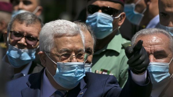Palestinian President Mahmud Abbas calls on people to wear protective masks as he walks in a street in the West Bank city of Ramallah on June 15, 2020. ABBAS MOMANI / AFP Palestinian President Mahmud Abbas calls on people to wear protective masks as he walks in a street in the West Bank city of Ramallah on June 15, 2020. ABBAS MOMANI / AFP