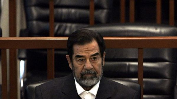 Ousted Iraqi President Saddam Hussein sits in court during the ‘Anfal’ genocide trial in Baghdad 06 December 2006. AFP