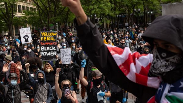 Demonstrators gather to protest the recent death of George Floyd on May 31, 2020 in Seattle, Washington. Protests due to the recent death of George Floyd took place in Seattle and its suburb of Bellevue, with looting in Bellevue and at least one burned automobile there. David Ryder/Getty Images/AFP David Ryder / GETTY IMAGES NORTH AMERICA / Getty Images via AFP