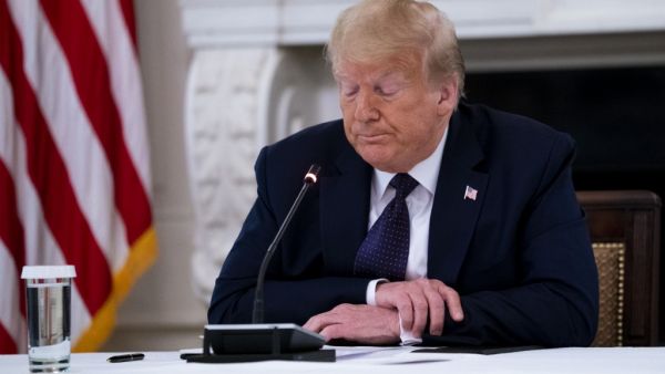 U.S. President Donald Trump pauses while making remarks as he participates in a roundtable with law enforcement officials in the State Dining Room of the White House, June, 8, 2020 in Washington, DC. From L-R is Attorney General William Barr, Daniel J, Cameron Attorney General for the Commonwealth of Kentucky, Trump. Doug Mills-Pool/Getty Images/AFP POOL / GETTY IMAGES NORTH AMERICA / Getty Images via AFP