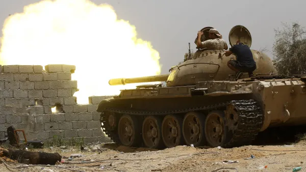 Forces loyal to the UN-recognised Government of National Accord (GNA) open tank fire from their position in the al-Sawani area south of the Libyan capital Tripoli during clashes with Haftar forces, June 13, 2019. (AFP)