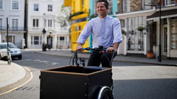 Reverend Pat, who worked as a curate before joining St Peter's in Notting Hill as a vicar in 2017,  travels his  London parish and beyond on a tricycle equipped with speakers. (AFP/File)