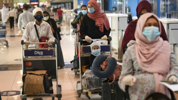 Indian nationals gather at the Dubai International Airport before leaving the country on a flight back to their country, May 7, 2020. /AFP