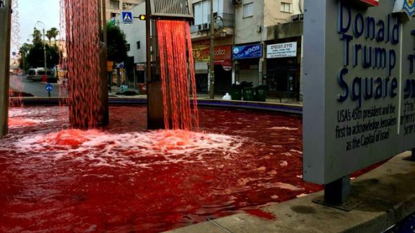 A fountain in Donald Trump Square in Petah Tikva is dyed red in a protest against West Bank annexation (screen capture via Twitter)