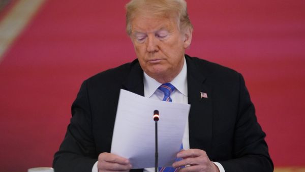 In this file photo taken on June 26, 2020 US President Donald Trump looks on during an American Workforce Policy Advisory Board Meeting in the East Room of the White House in Washington, DC. Donald Trump received a written briefing about alleged Russian bounties offered to Afghan militants to kill American troops as early as February, The New York Times said on June 29, 2020 in a new report undercutting the US president's assertion that he was not told of the threat. MANDEL NGAN / AFP