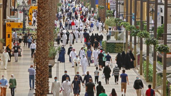 Kuwaitis wearing face masks walk inside the re-opened Avenues Mall, the country's largest shopping centre, on June 30, 2020 in Kuwait City after almost a four-months shutdown to prevent the spread of the coronavirus COVID-19 in the country. YASSER AL-ZAYYAT / AFP