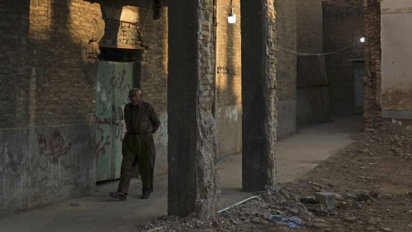 A man walks in the vicinity of Arbil Citadel in the capital of the northern Iraqi Kurdish autonomous region. SAFIN HAMED / AFP