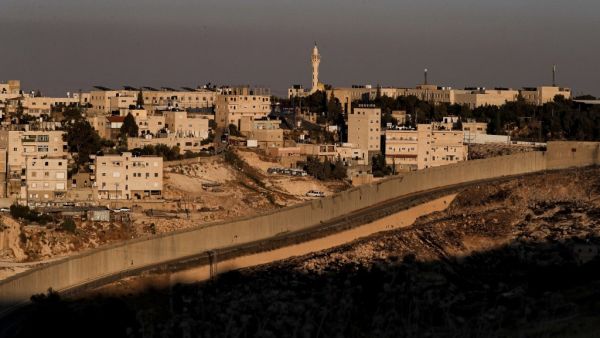 This picture taken on June 30, 2020 shows a view of Israel's controversial separation barrier between the West Bank city of Abu Dis (background) and East Jerusalem (foreground). AHMAD GHARABLI / AFP This picture taken on June 30, 2020 shows a view of Israel's controversial separation barrier between the West Bank city of Abu Dis (background) and East Jerusalem (foreground). AHMAD GHARABLI / AFP