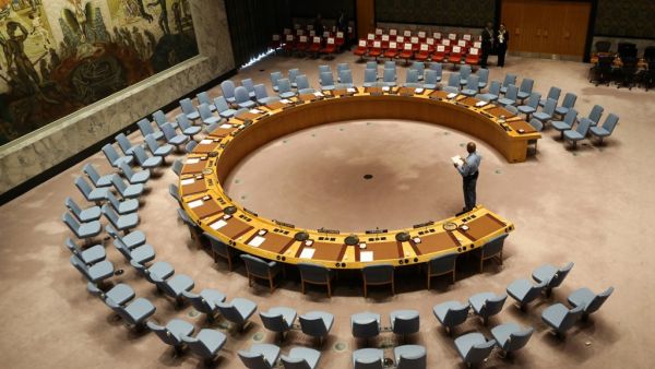 In this file photo taken on September 20, 2017 an official looks at the empty chairs of leaders ahead of their participation in an open debate of the United Nations Security Council in New York. The UN Security Council on July 1, 2020 unanimously adopted a resolution calling for a halt to conflicts to facilitate the fight against the COVID-19 pandemic, after more than three months of painstaking negotiations, diplomats said. Stephane LEMOUTON / POOL / AFP