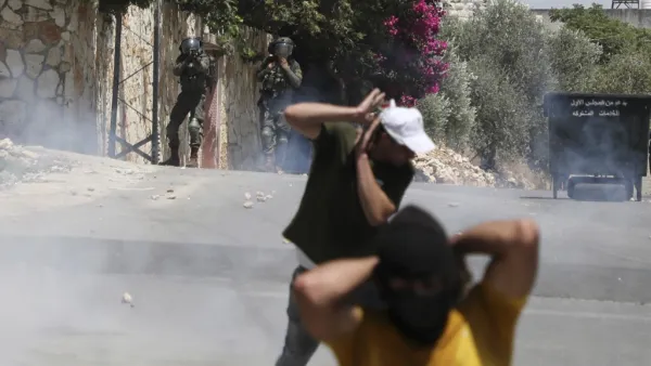 Palestinian protesters run for cover as Israeli troops fire tear gas towards the crowd during a demonstration in the village of Kfar Qaddum in the occupied West Bank against the Jewish state's plans to annex part of the Palestinian territory on July 3, 2020. Rival Palestinian factions Fatah and Hamas pledged the previous day a united campaign against Israel's prospective plans to annex territory in the occupied West Bank, in a rare joint press conference, spurred by their common opposition to US President D