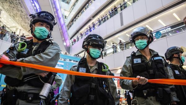 Riot police stand guard during a clearance operation during a demonstration in a mall in Hong Kong on July 6, 2020, in response to a new national security law introduced in the city which makes political views, slogans and signs advocating Hong Kong’s independence or liberation illegal. Hong Kongers are finding creative ways to voice dissent after Beijing blanketed the city in a new security law and police began making arrests for people displaying now forbidden political slogans. ISAAC LAWRENCE / AFP