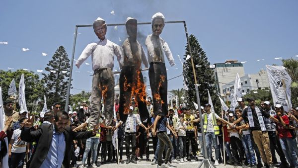Palestinian supporters of al-Ahrar movement burn effigies depicting (L to R) US President Donald Trump, Trump's Middle East peace plan dubbed as the "Deal of the Century", and Israeli Prime Minister Benjamin Netanyahu, during a demonstration against Israel's plans to annex parts of the occupied West Bank. MOHAMMED ABED / AFP