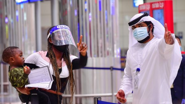 A tourist receives instruction at Dubai airport in the United Arab Emirates on July 8, 2020, as the country reopened its doors to international visitors in the hope of reviving its tourism industry after a nearly four-month closure. GIUSEPPE CACACE / AFP