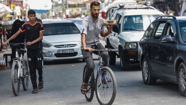 Hamuda's modest coffee on wheels business is giving the coastal Palestinian territory its first taste of a delivery service inspired by the likes of Uber Eats or Deliveroo. SAID KHATIB / AFP