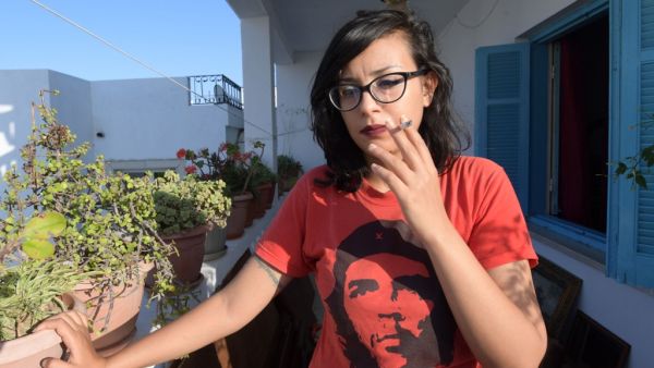 Emna Charki, 27, a Tunisian woman who was sentenced to six months in jail by a Tunis court over a parody posted on Facebook linking the Koran and COVID-19, poses for a picture on July 14, 2020 before starting her jail sentence. (AFP/ File)