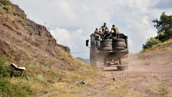 Armenian servicemen transport used tyres in the back of a truck to fortify their positions on the Armenian-Azerbaijani border near the village of Movses on July 15, 2020. Defence officials in Armenia and Azerbaijan said fighting on their border subsided on July 15, 2020 after several days of deadly clashes raised fears of a major flare-up. At least 16 people on both sides were killed in three days of shelling that started Sunday between the ex-Soviet republics, which have been locked for decades in a confli