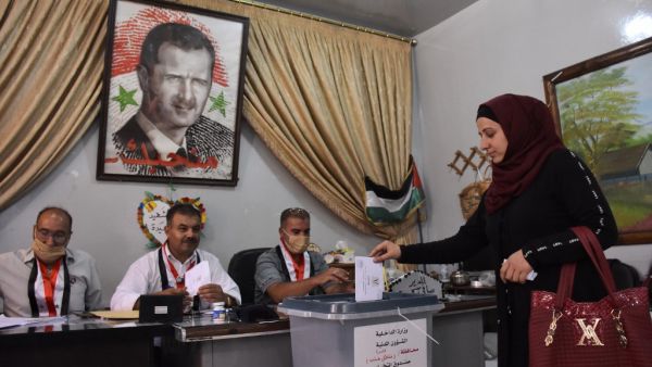 A Syrian woman casts her ballot at a polling station in the Nubl neighbourhood of Aleppo on July 19, 2020, during the parliamentary elections. Syrians vote today to elect a new parliament as the Damascus government grapples with international sanctions and a crumbling economy after retaking large parts of the war-torn country. AFP