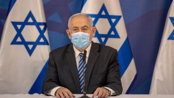 Israeli Prime Minister Benjamin Netanyahu wears a protective face mask before issuing a statement at the Israeli Defence Ministry in Tel Aviv on July 27, 2020 following the high tensions with the Lebanese militant group Hezbollah at the Israeli-Lebanon border. Tal SHAHAR / POOL / AFP