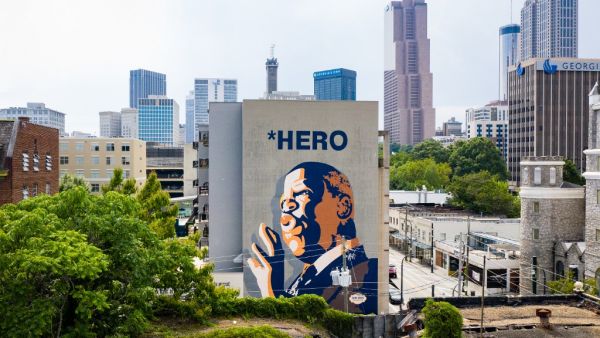  In this drone image, a mural of U.S. Rep John Lewis is seen on the side of a building on July 18, 2020 in Atlanta, Georgia. John Lewis, died at 80 years old, was an icon leader in the civil rights moment and the Voting Rights Act and served as a United States Congressman for 33 years. Elijah Nouvelage/Getty Images/AFP