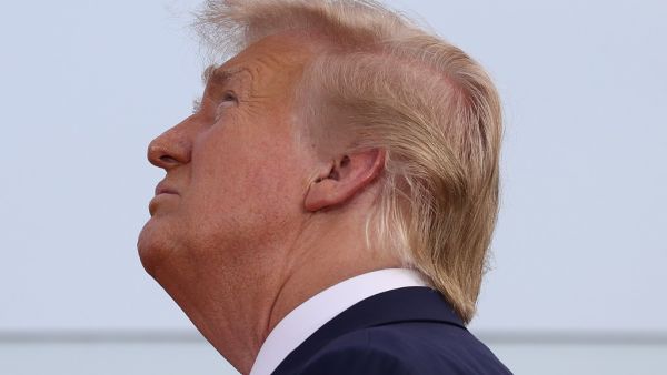 President Donald Trump watches as military aircraft perform a flyover near the White House on July 04, 2020 in Washington, DC. President Trump is hosting a "Salute to America" celebration that includes flyovers by military aircraft and a large fireworks display. Tasos Katopodis/Getty Images/AFP TASOS KATOPODIS / GETTY IMAGES NORTH AMERICA / Getty Images via AFP