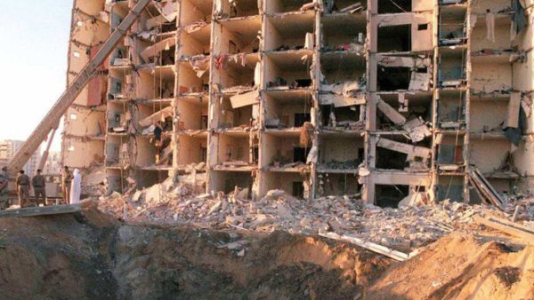 In this file photo taken on 27 June, military personnel survey the damage to Khobar Towers caused by the 25 June explosion of a fuel truck outside the northern fence of the facility on King Abdul Aziz Air Base near Dhahran, Saudi Arabia. (AFP)