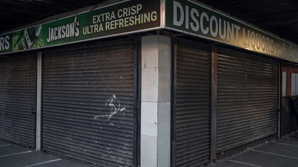 In this file photo taken on April 17, 2020 a closed liquor store is seen in Hillbrow, Johannesburg. South African reiterated on July 12, 2020 that the sale and export of alcohol in South Africa is forbidden as curfew was re-imposed as coronavirus infections spike. MARCO LONGARI / AFP