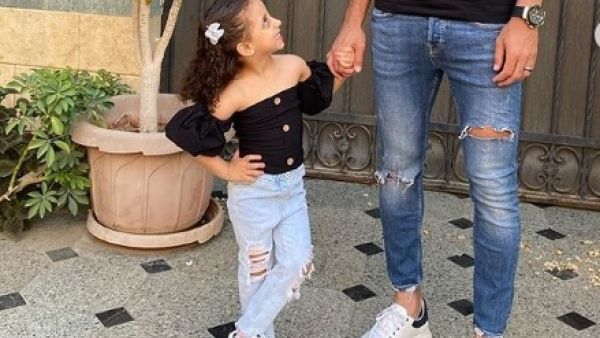 Amre Soulia is seen holding his daughter’s hand while she smiles back at him (Instagram)