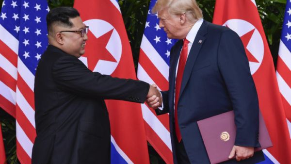 North Korea leader Kim Jong Un and U.S. President Donald Trump shaking hands in Singapore in June 2018 | Susan Walsh/AFP via Getty Images