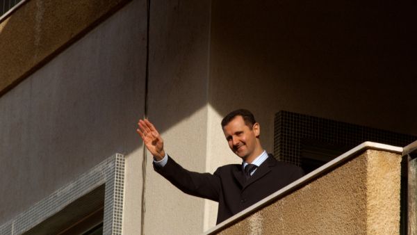 The Syrian President Bashar al Assad waves to his supporters during a pro government demonstration in the center of Damascus, Syria. (Shutterstock/ File Photo)