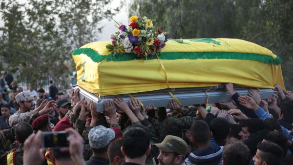 Hezbollah Funeral,where village citizens and Hezbollah soldiers carry the coffin of "Mohammad Wehbi" the Hezbollah fighter who was killed in Syria war. (Shutterstock/ File Photo)