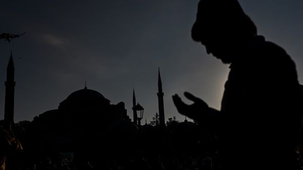A man wearing a fez prays during the Eid al-Adha prayers outside Hagia Sophia in Istanbul on July 31, 2020. Muslims are celebrating Eid al-Adha or feast of sacrifice, the second of two Islamic holidays celebrated worldwide marking the end of the annual pilgrimage or Hajj to the Saudi holy city of Mecca. Ozan KOSE / AFP