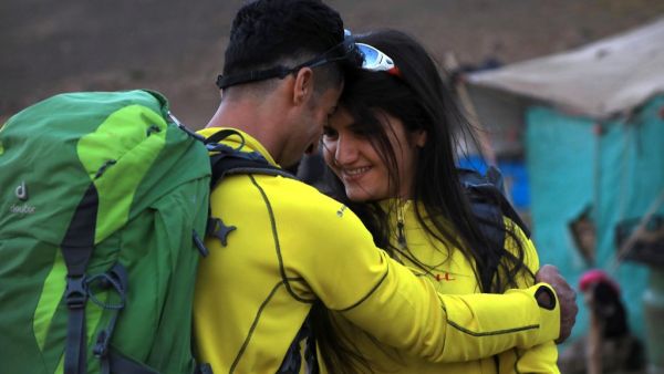 Newlyweds Iraqi Kurds Salar Chomany, 34, and Soma Mohammed, 28, walk together during a trekking ceremony at Mount Halgurd, in Iraq's autotomous Kurdistan region, on the first day of their honeymoon, on August 2, 2020. The couple met while hiking in the mountain, a sport that gained popularity recently in Iraqi Kurdish areas, and decided it would be the theme of their wedding. SAFIN HAMED / AFP