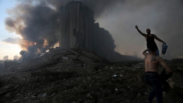 A picture shows the scene of an explosion in Beirut on August 4, 2020. Two huge explosion rocked the Lebanese capital Beirut, wounding dozens of people, shaking buildings and sending huge plumes of smoke billowing into the sky. Lebanese media carried images of people trapped under rubble, some bloodied, after the massive explosions, the cause of which was not immediately known.  STR / AFP