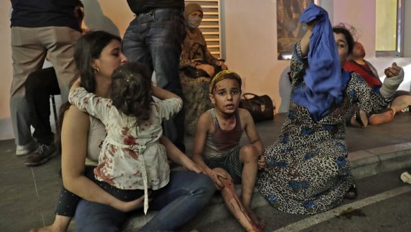 Wounded people wait to received help outside a hospital following an explosion in the Lebanese capital Beirut on August 4, 2020. IBRAHIM AMRO / AFP